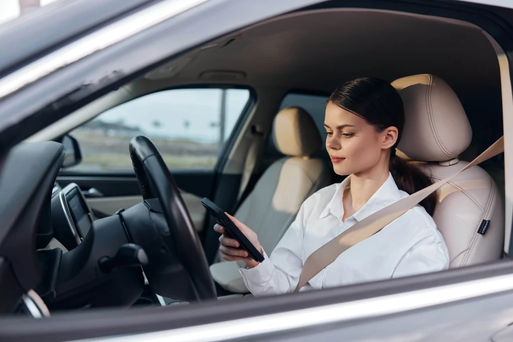 a-woman-is-seated-in-the-driver-s-seat-of-her-car-2025-03-10-22-46-12-utc-min