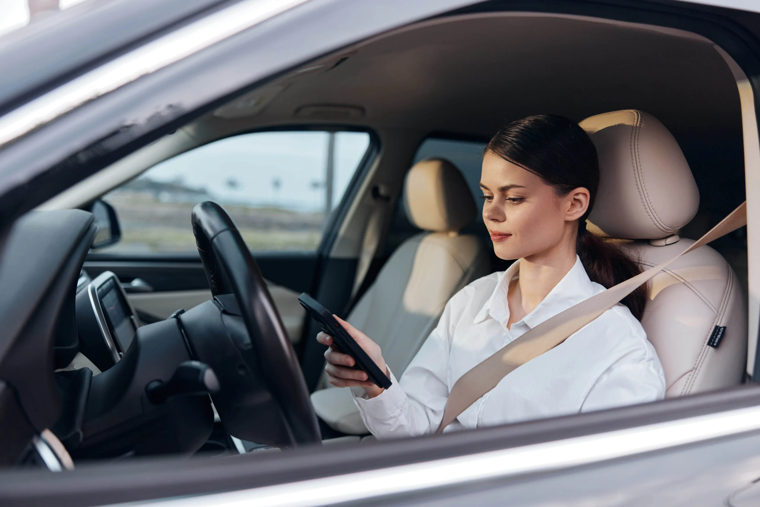 a-woman-is-seated-in-the-driver-s-seat-of-her-car-2025-03-10-22-46-12-utc-min