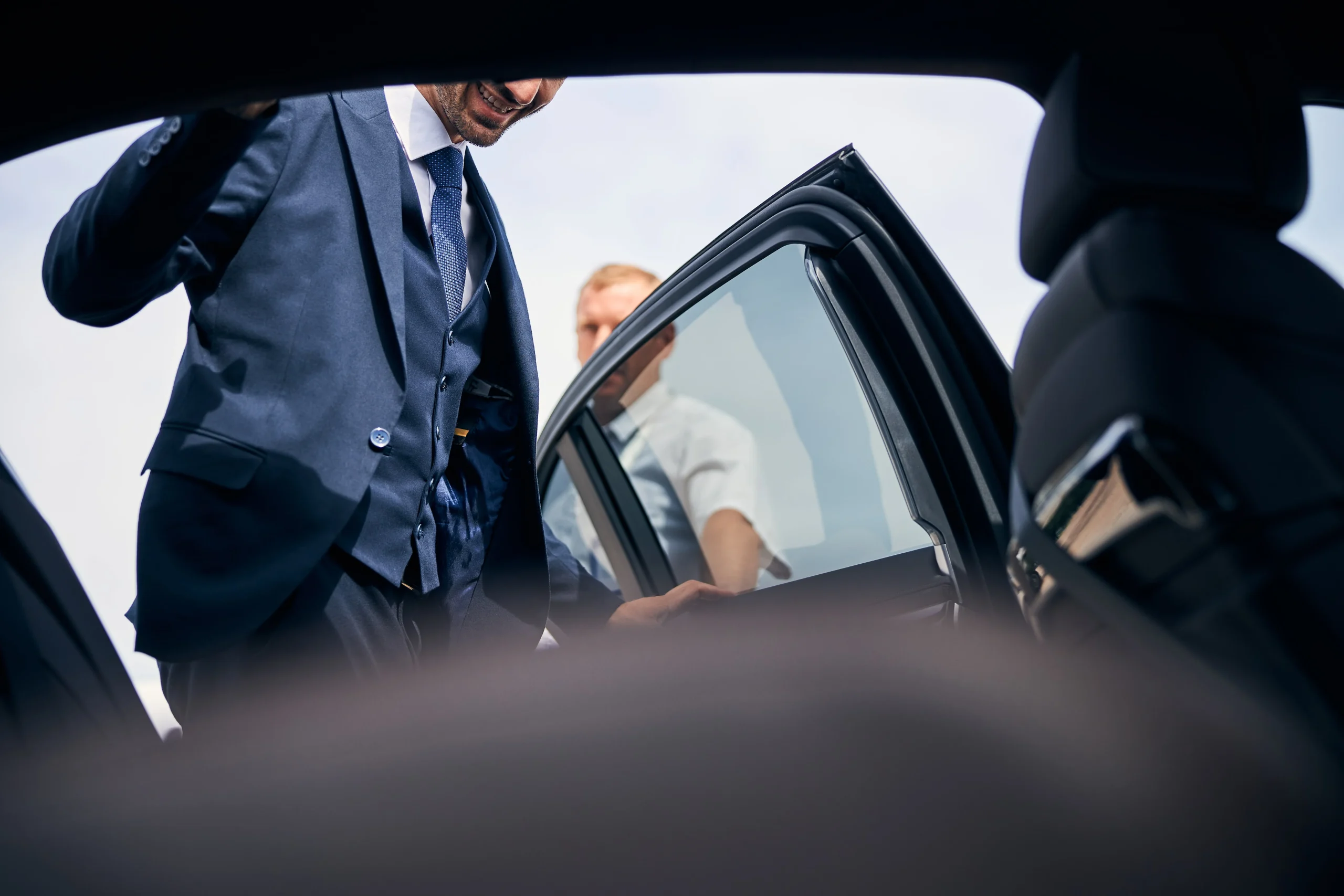 cheerful-businessman-getting-into-a-backseat-of-a-2024-10-20-22-45-03-utc-min